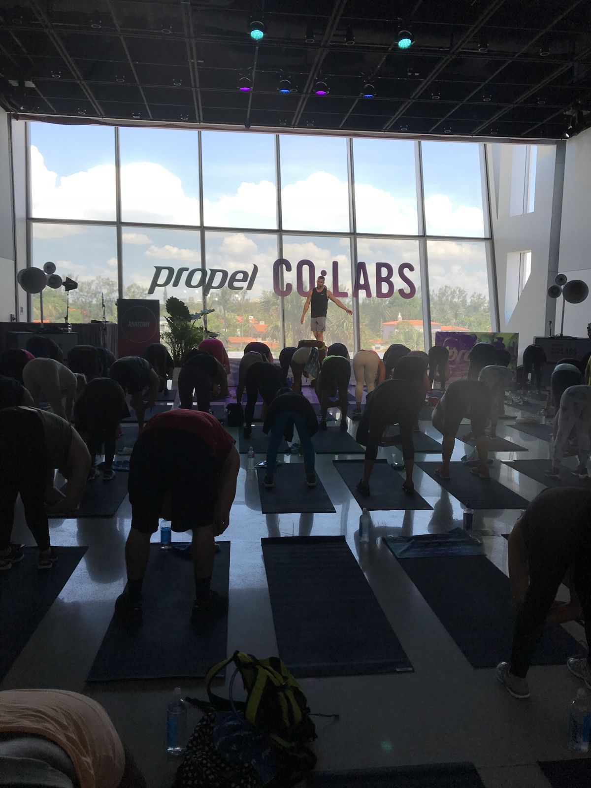 A packed room facing Grant Weeditz as he coaches from the stage by the windows at Faena, Miami Beach