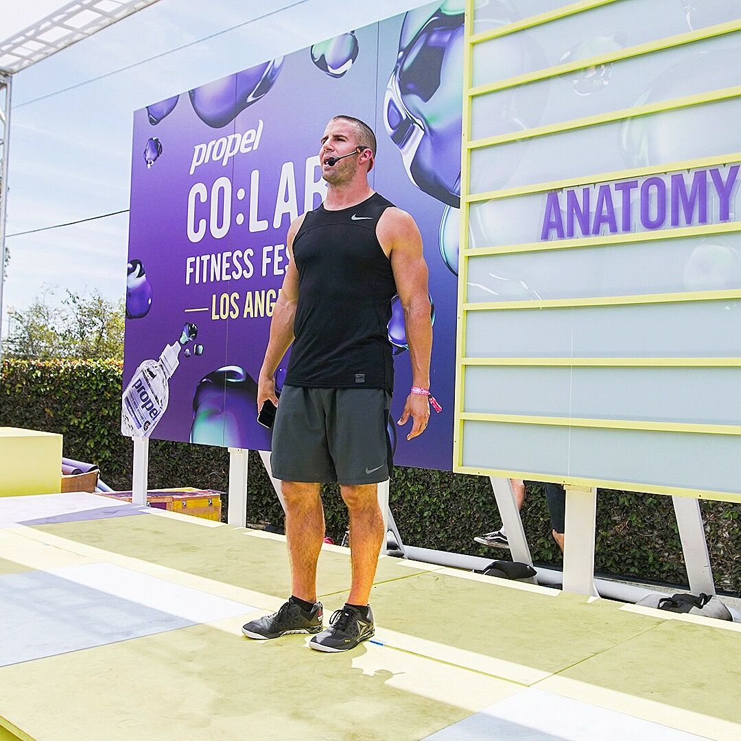 Grant Weeditz on stage in front of the CO:LABS Los Angeles banner and an Anatomy sign