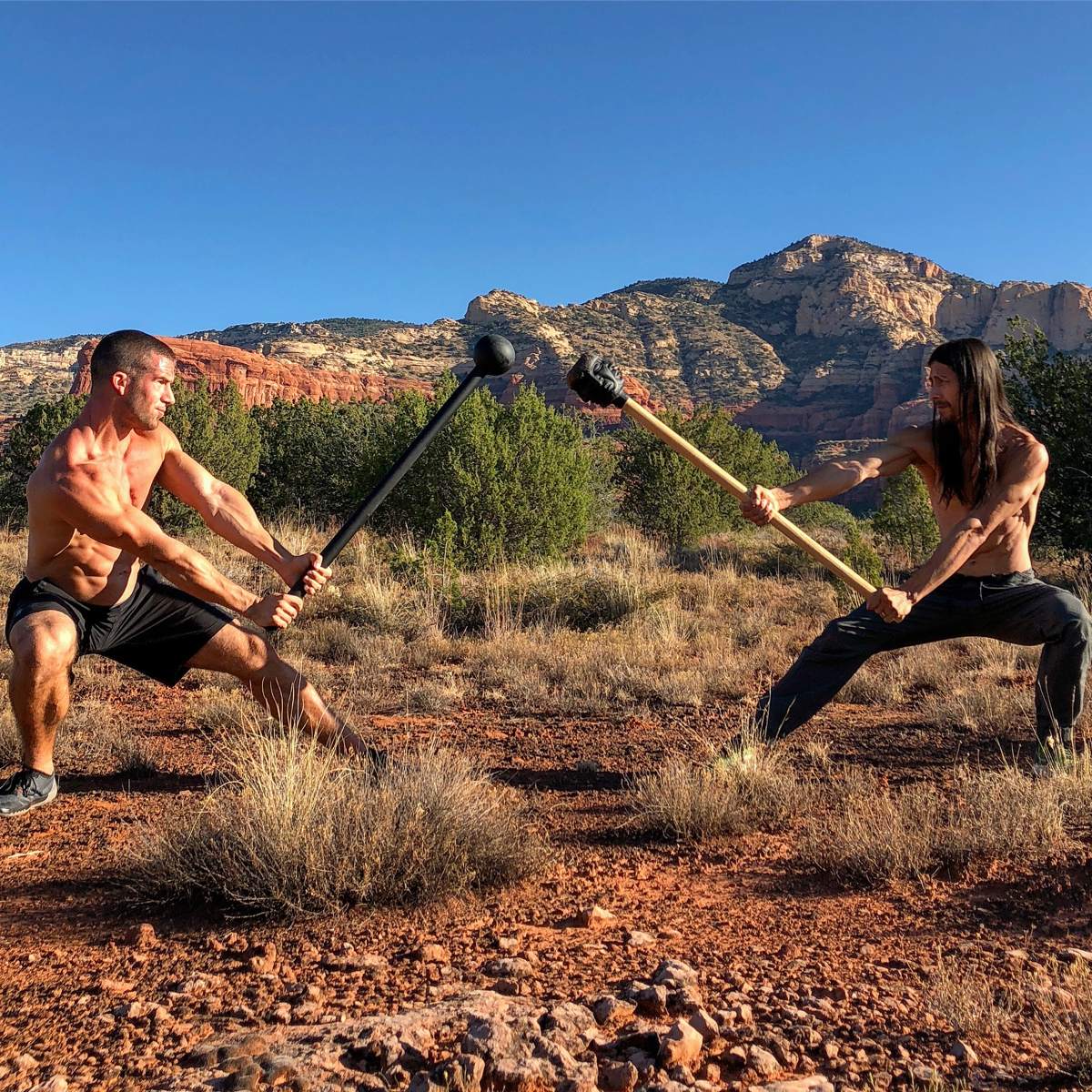 Grant Weeditz and another trainer facing off with steel maces in front of red rock formations in Sedona, Arizona